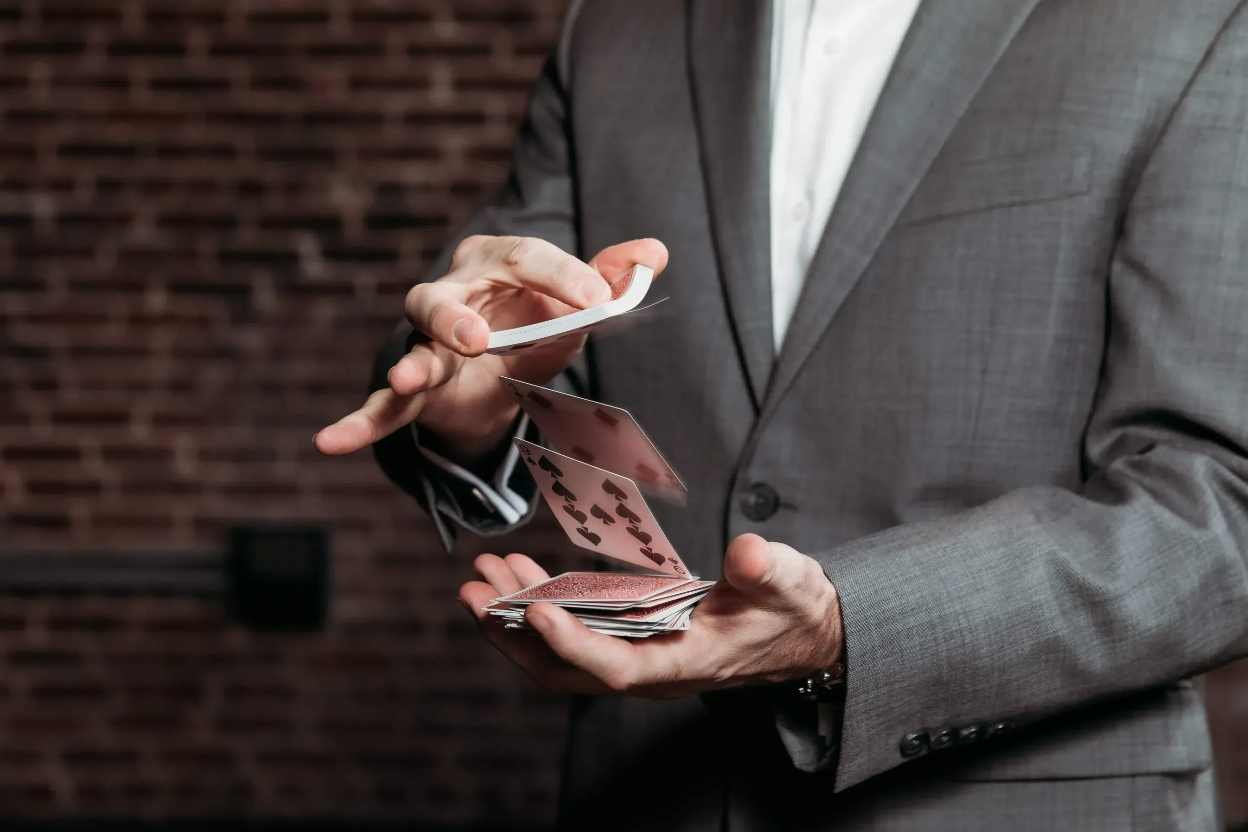Dribbling a deck of cards between his fingers.