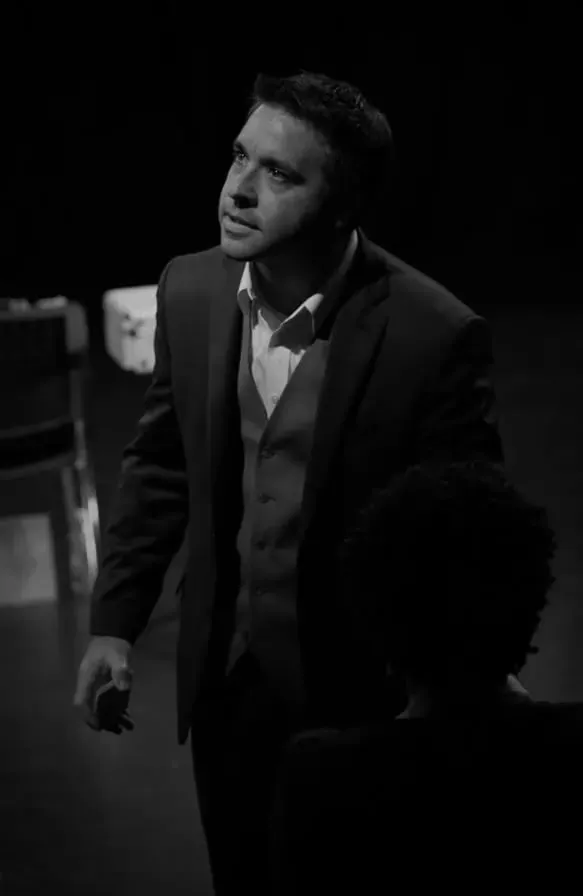 Matt in profile, performing at a corporate event.