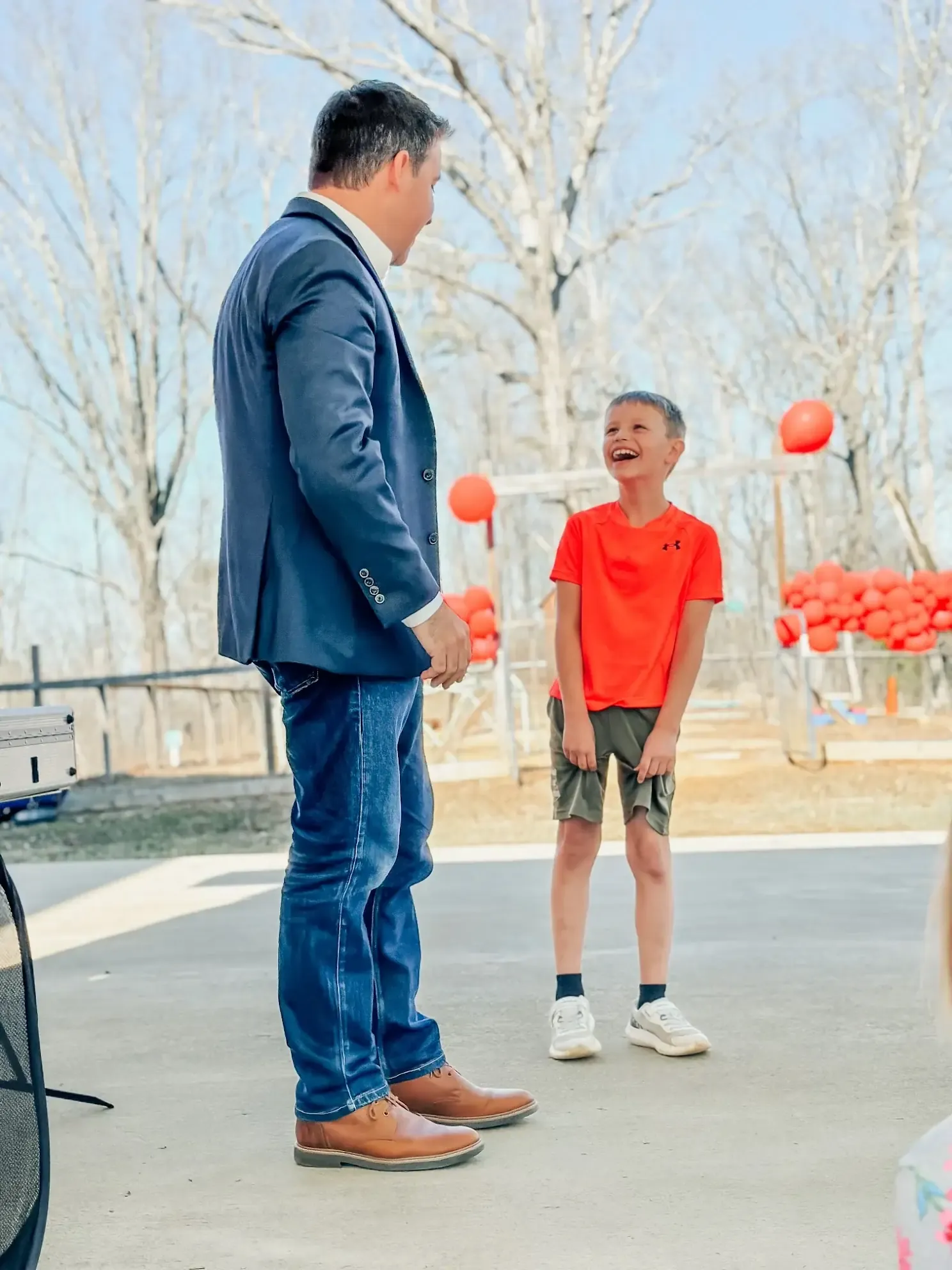 A boy laughing during the family show at his 8th birthday party.